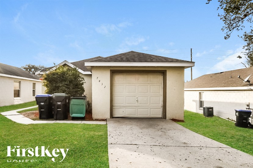 A garage with a white door and a brown roof is shown.