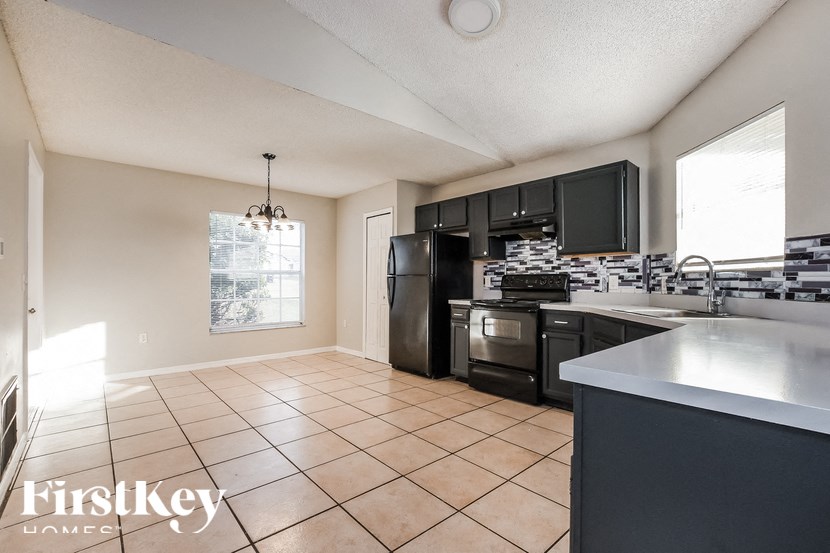 A kitchen with a stove top oven and a microwave.