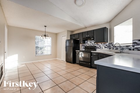 A kitchen with a stove top oven and a microwave.