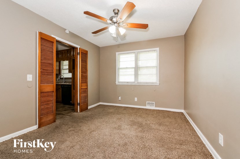 the master bedroom is spacious and has a ceiling fan