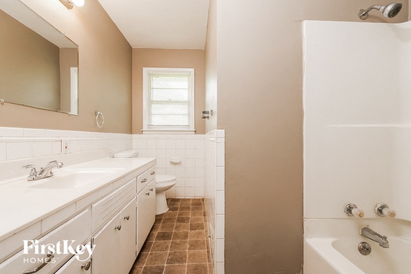 a bathroom with a sink toilet and tub and a shower