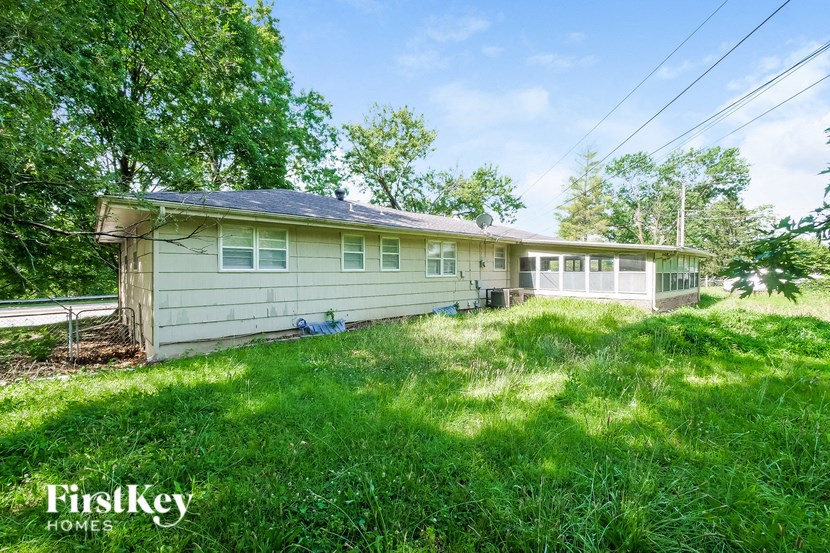 a small white house with a yard in front of it