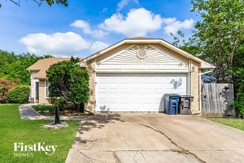 a white garage door in front of a house