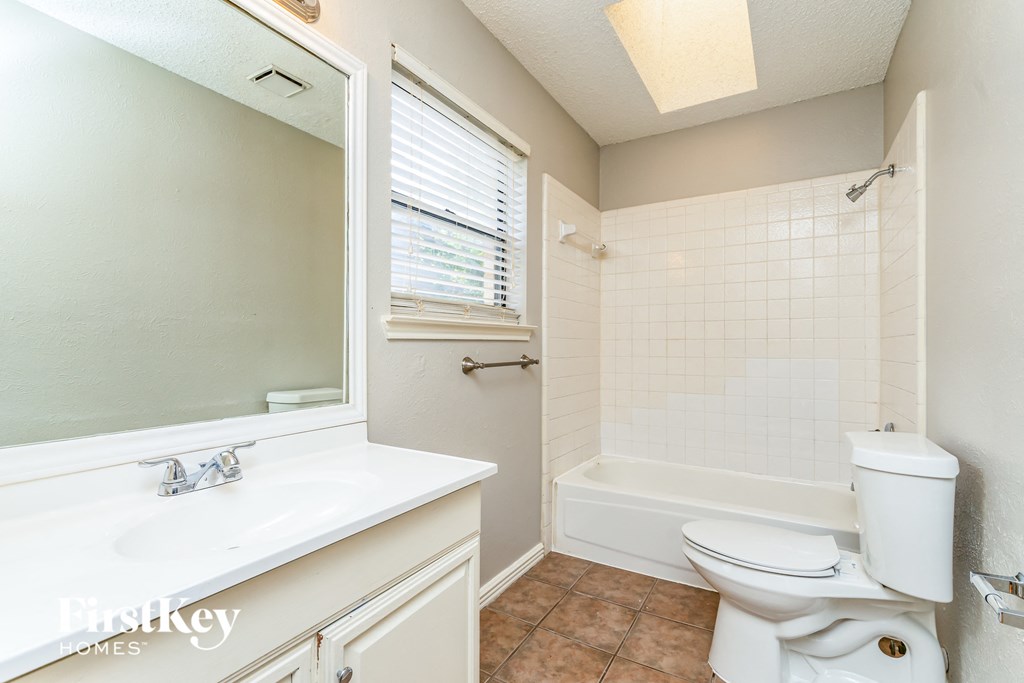 a bathroom with a toilet and a sink and a bath tub