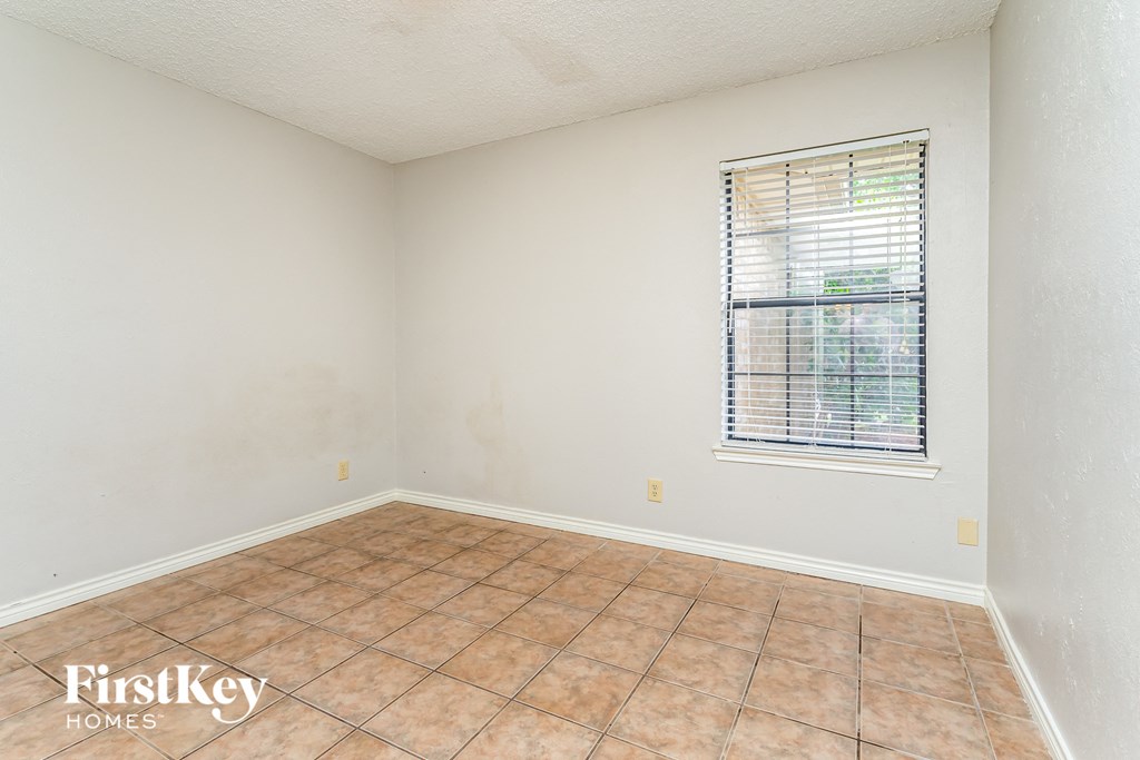 the living room of an empty house with a window