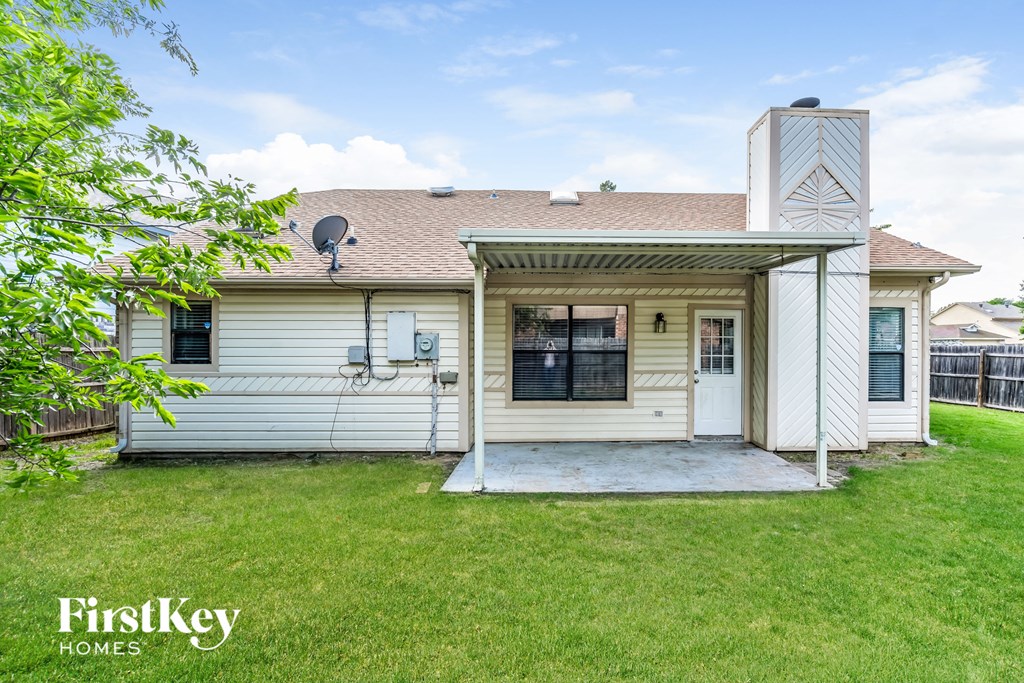 a small white house with a yard and a porch
