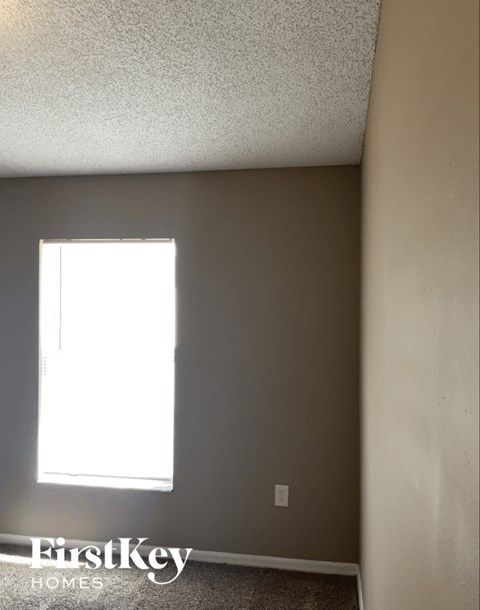 A room with a window and a FirstKey Homes logo.