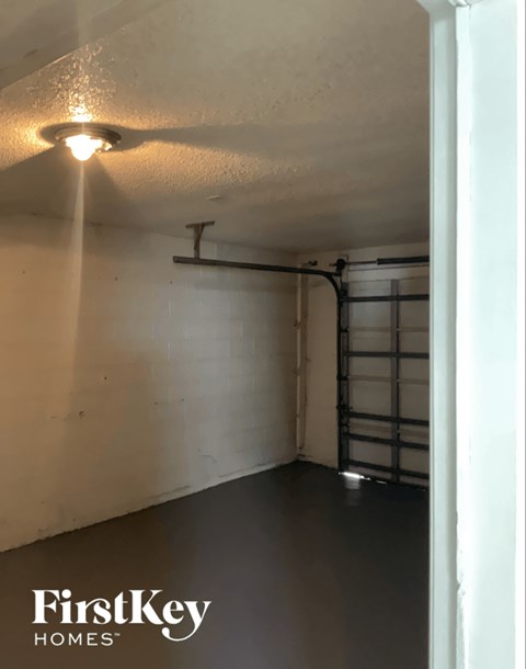A FirstKey Homes branded empty room with a light on the ceiling.