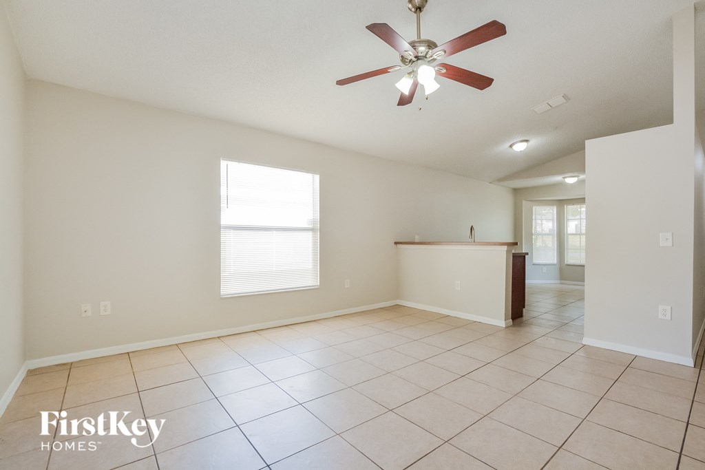 A spacious room with a fan and a window.