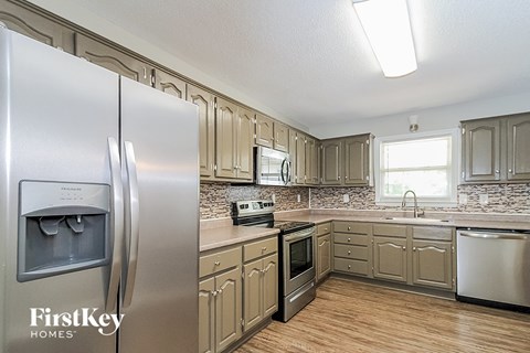 a kitchen with stainless steel appliances and white cabinets