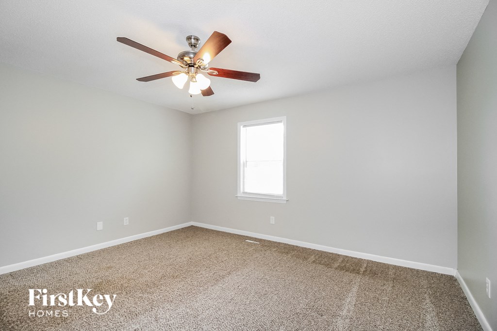 the master bedroom is spacious and has a ceiling fan