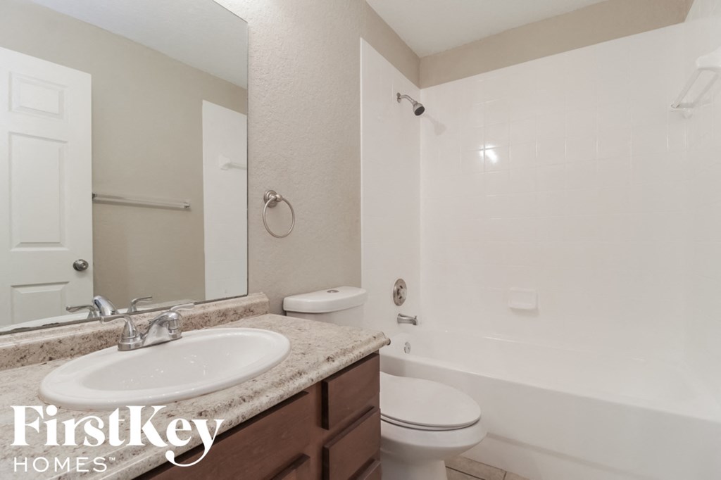 a bathroom with a sink and a toilet and a shower