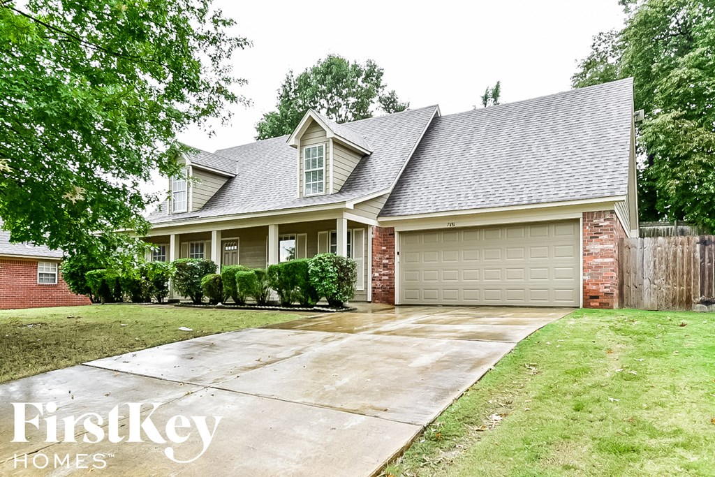 a suburban house with a driveway and a garage door
