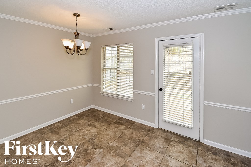the living room of a house with a white door and window