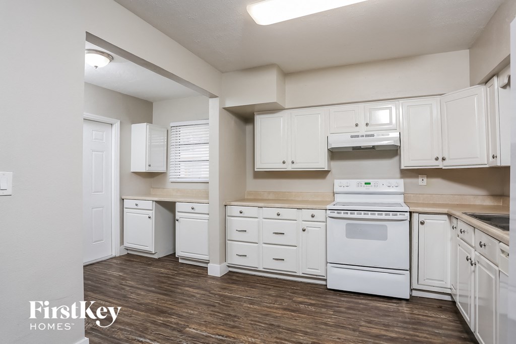a white kitchen with white appliances and white cabinets