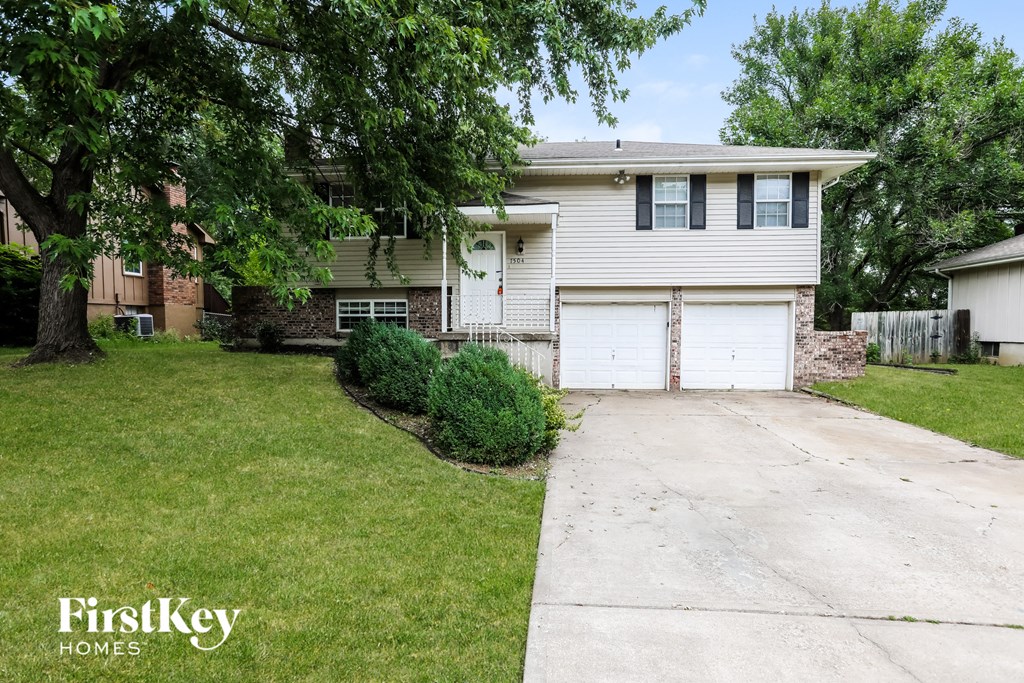 A house with a white garage door is for sale.