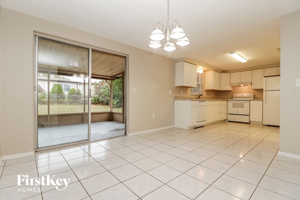 an open kitchen and living room with a sliding glass door to a patio