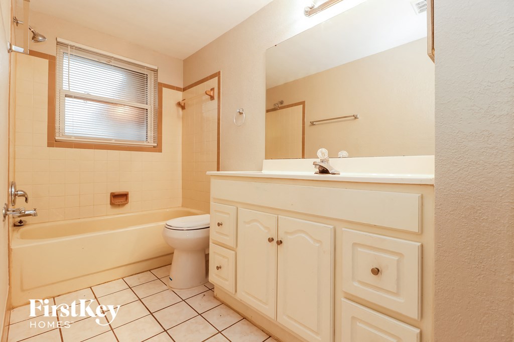 a bathroom with a toilet and a sink and a tub