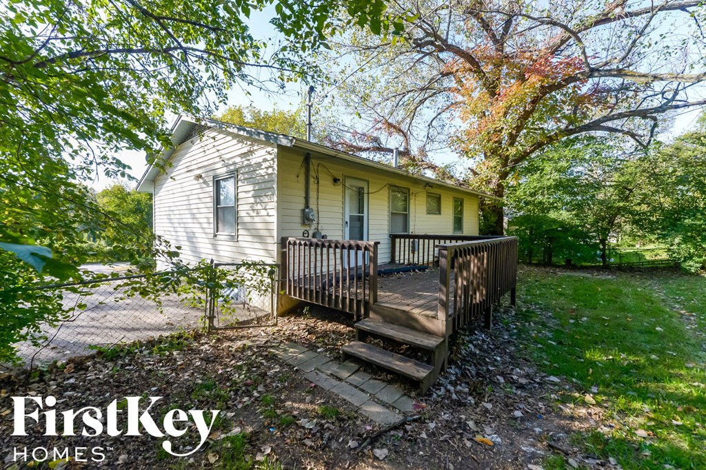 a small house with a wooden deck in front of it