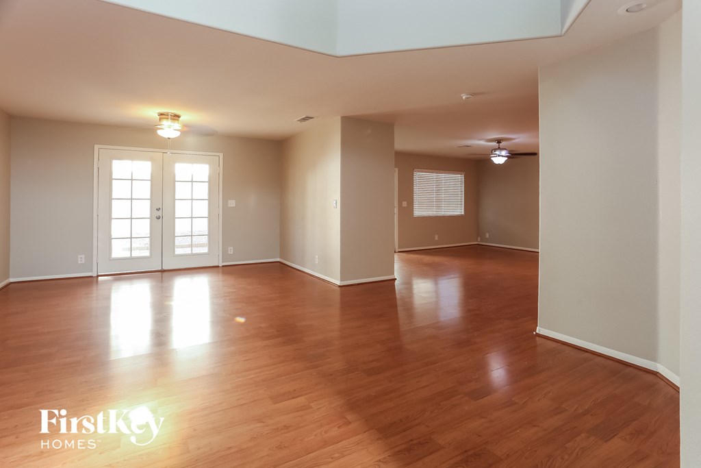 A room with wooden floors and a FirstKey Homes logo.