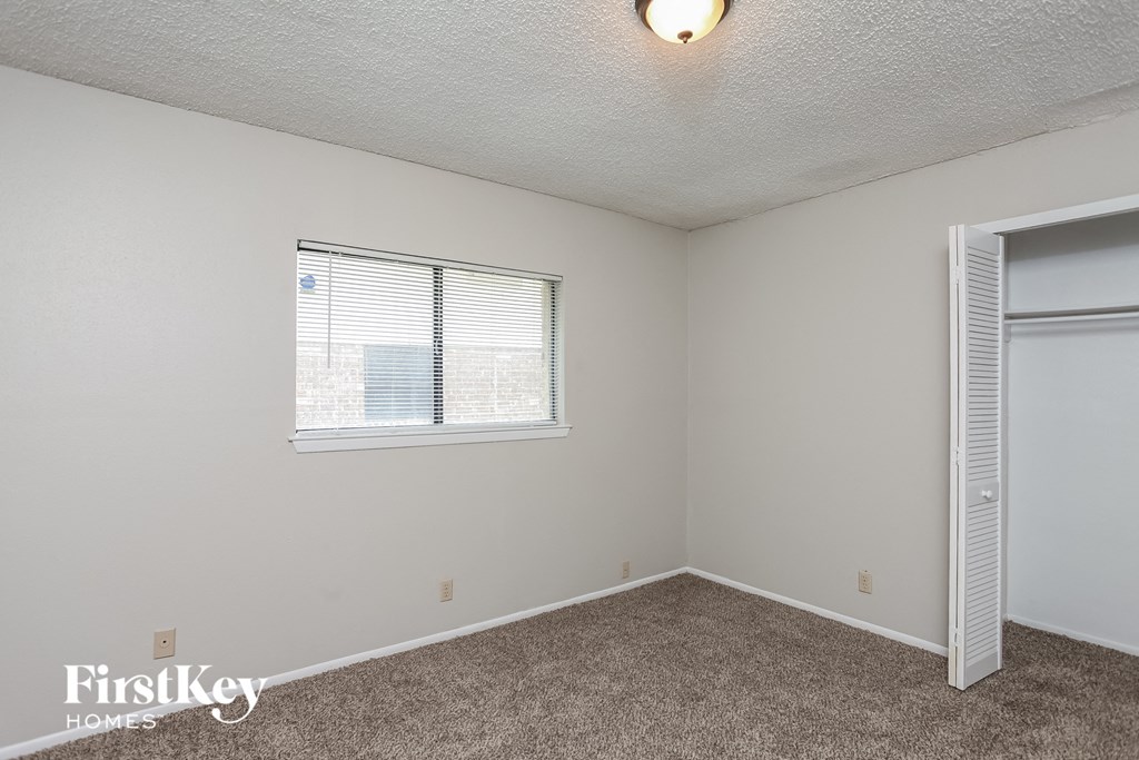 the living room of an apartment with a window and a door