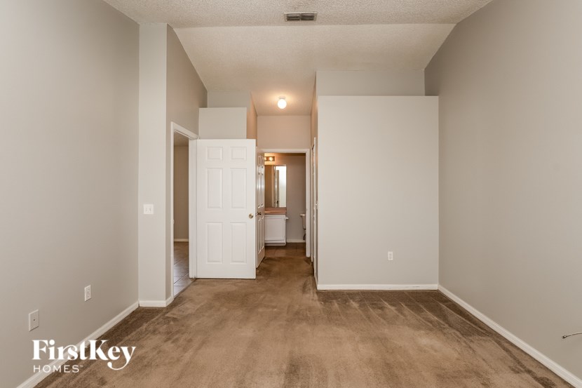 A room with a white door and a white wall.