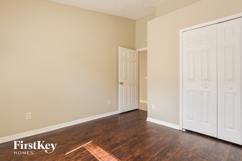 a living room with wood floors and white doors