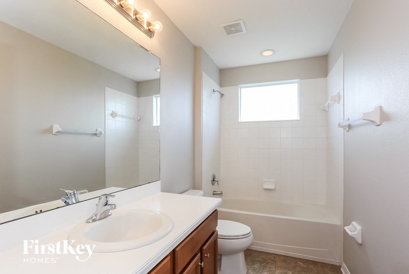 A bathroom with a white sink and toilet.