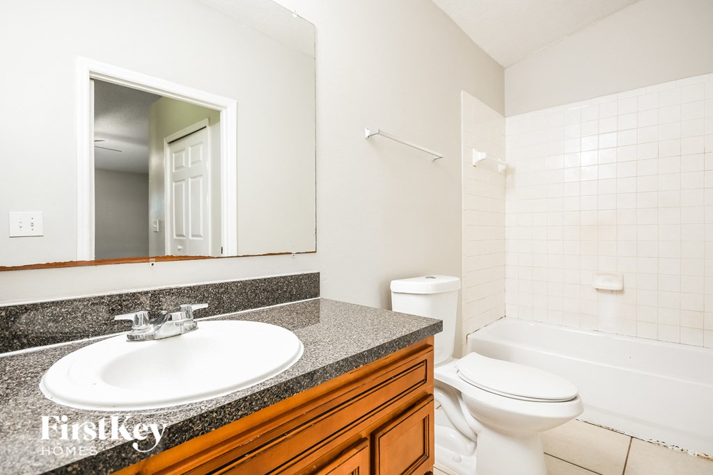 a bathroom with a sink and a toilet and a mirror
