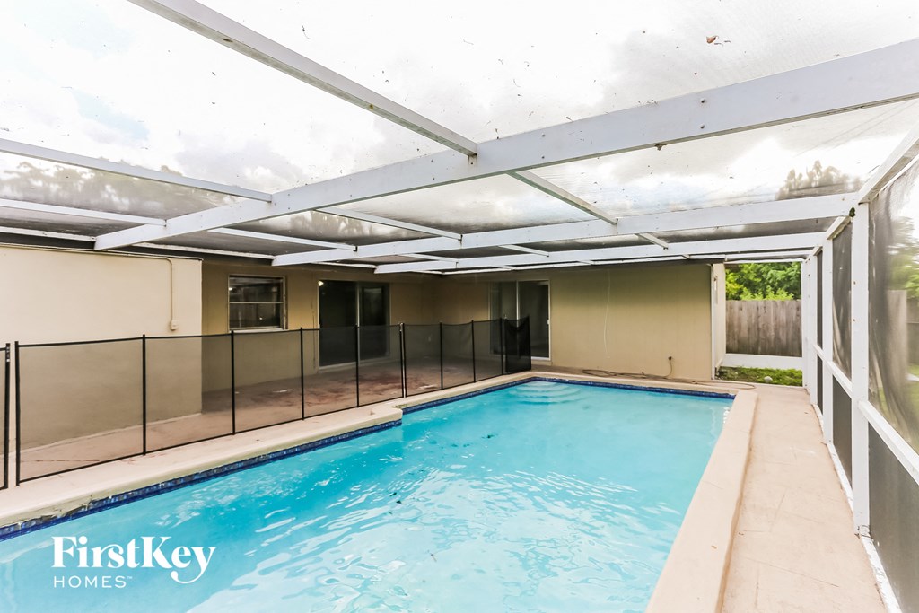 a large swimming pool in a house with a glass roof
