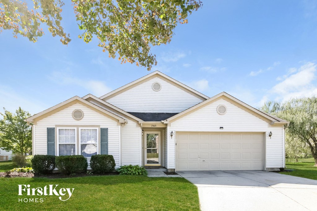 A white house with a garage is for sale by FirstKey Homes.