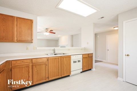 A kitchen with wooden cabinets and a white countertop.
