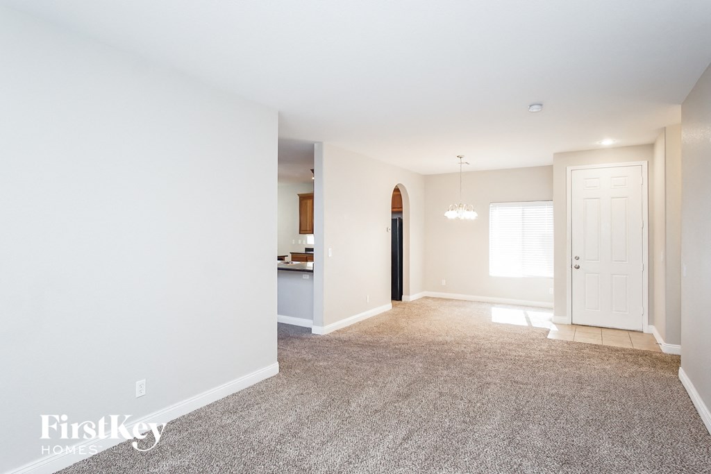 a living room with a carpeted floor and a white door