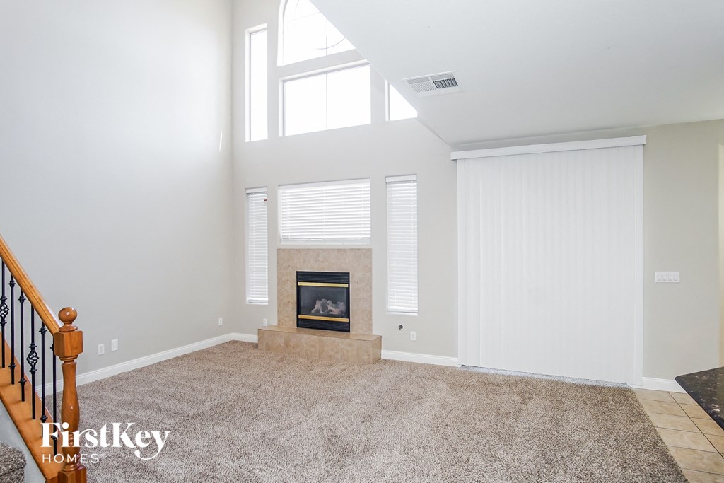 the living room has a fireplace and a large window