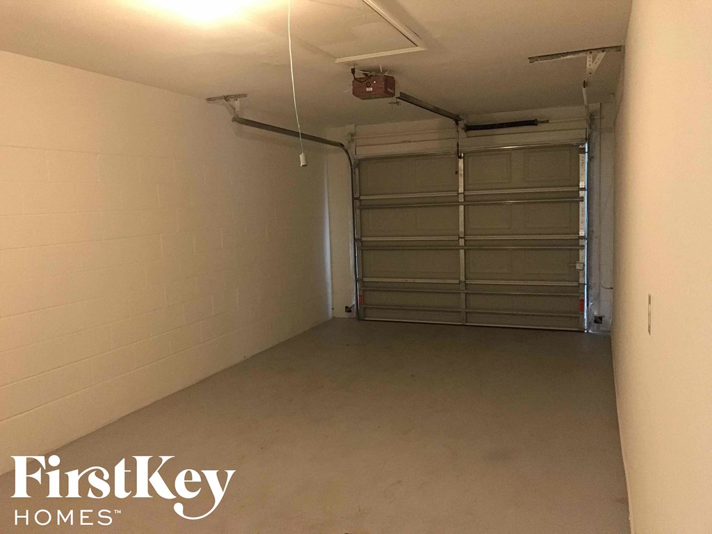 A spacious garage with a closed shutter door is available for rent.