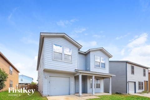 A two-story house with a garage is for sale.