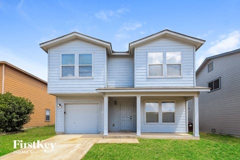 A two-story house with a garage is for sale.