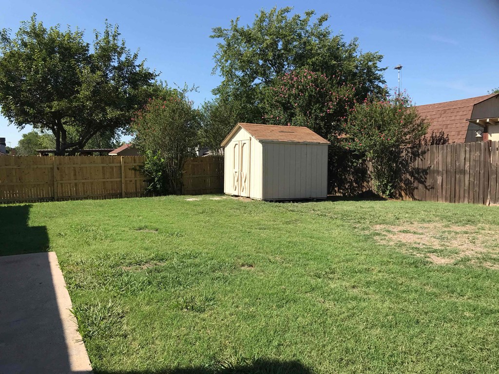 a backyard with a shed in the back yard