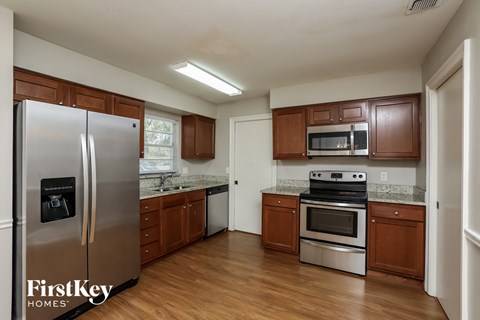a kitchen with wooden cabinets and stainless steel appliances