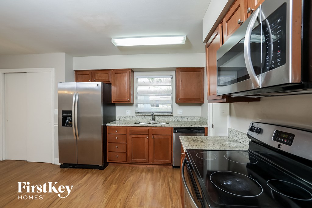 a kitchen with stainless steel appliances and wooden cabinets