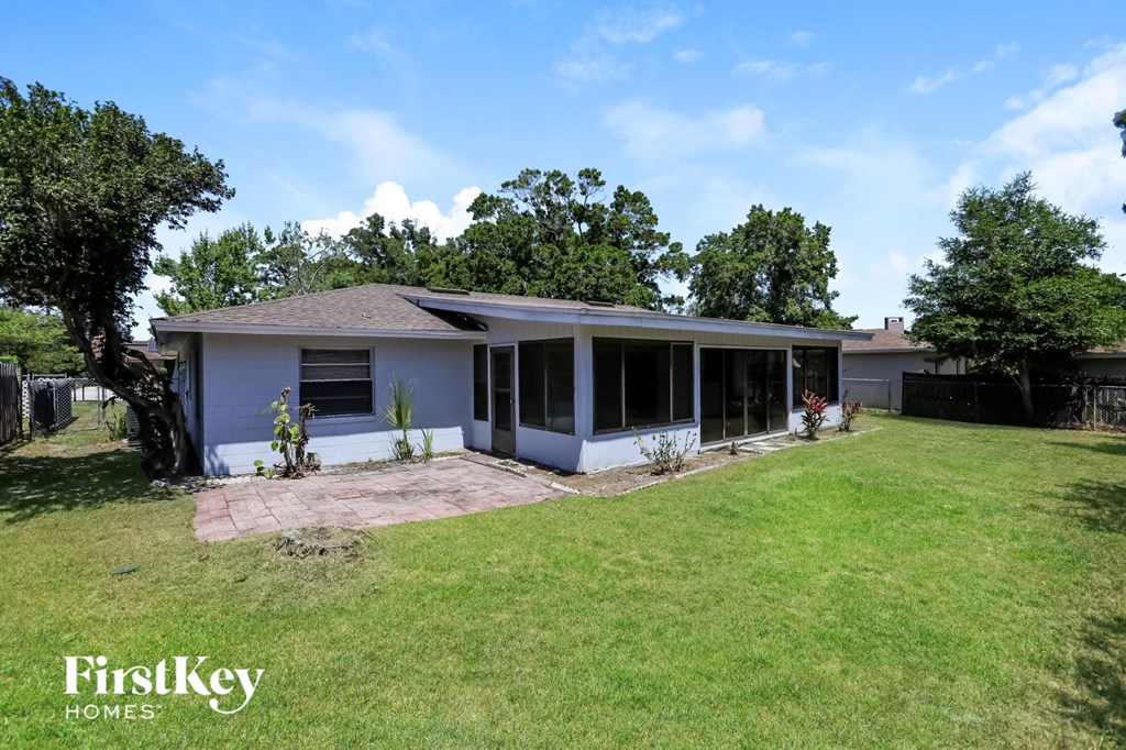 a small white house with a lawn and a yard