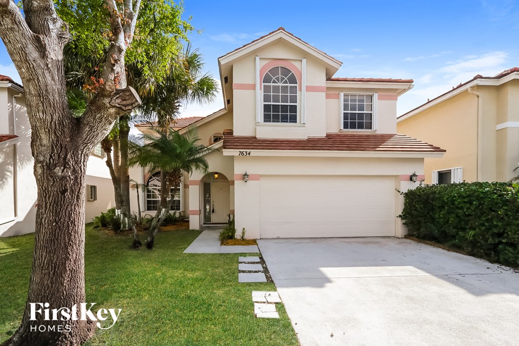 A house with a white garage door and a brown roof.