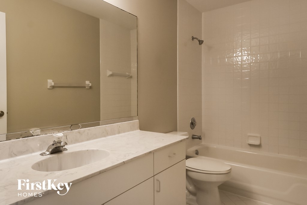 A white sink and toilet in a bathroom.
