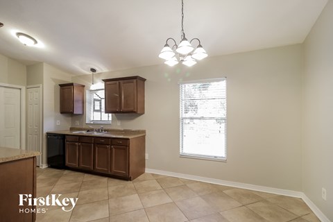 a kitchen with wooden cabinets and a sink and a window