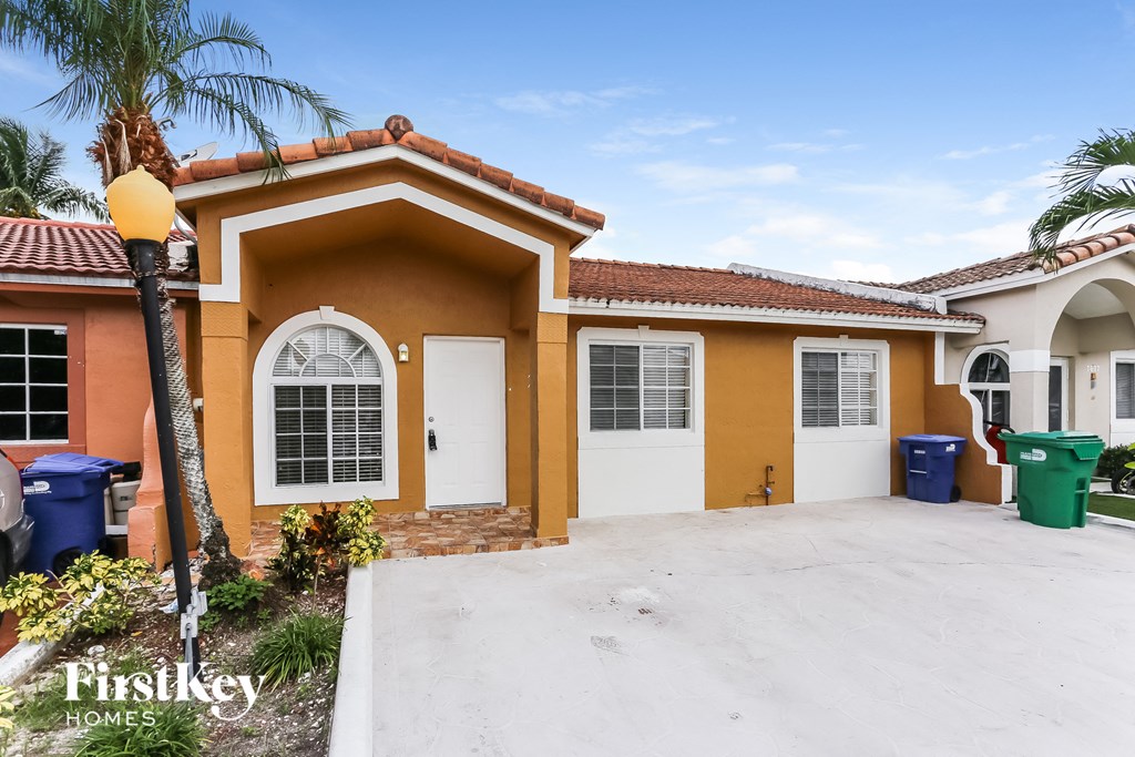 A house with a brown and orange exterior is for sale.