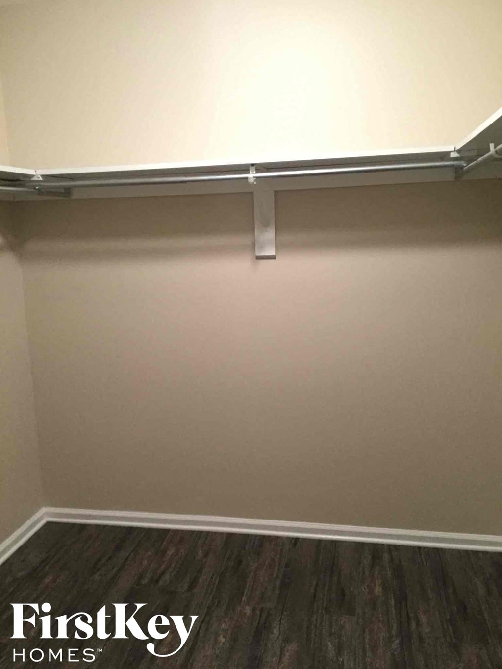 a room with a white wall and a sliding closet door