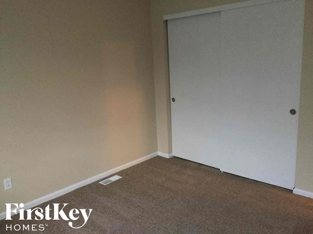 an empty room with a white wall and a door
