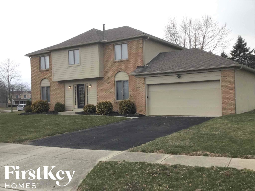 a house with a driveway and a garage door