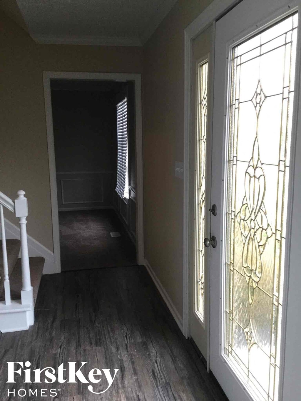 a view of the hallway from the front door of a house