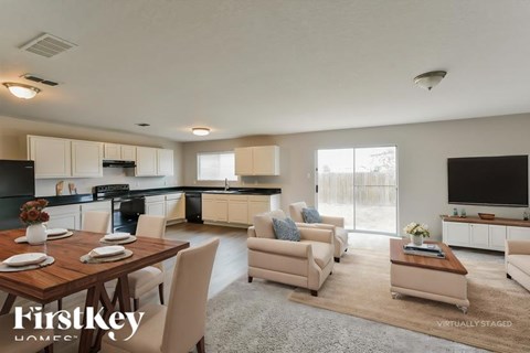 A modern kitchen with a dining table set for four.